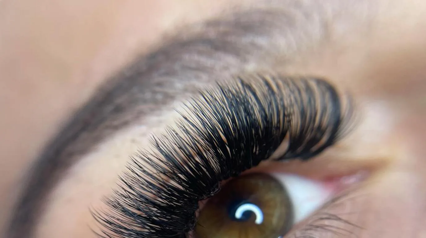 Close-up of natural-looking lash extensions in soft light